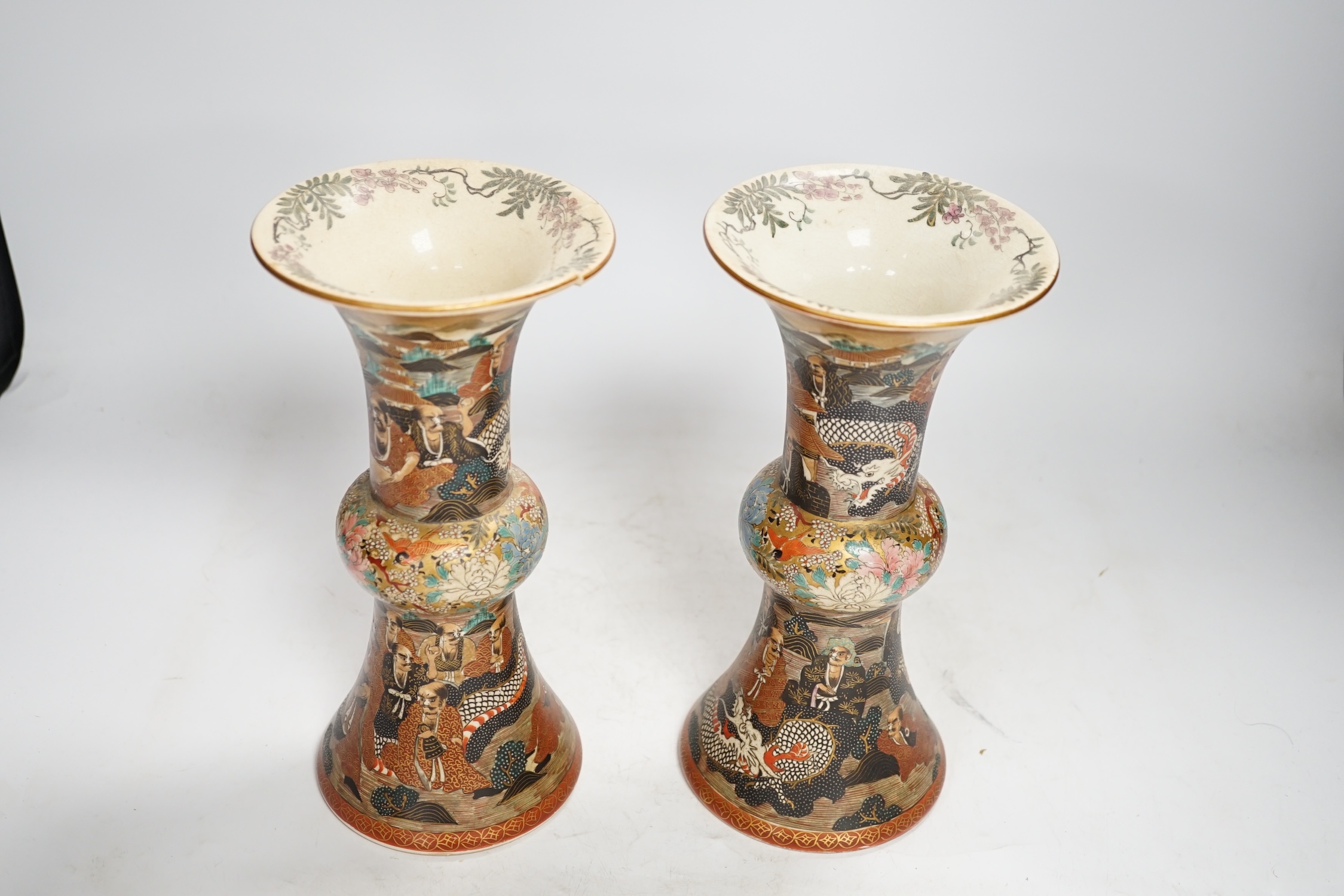 A pair of Japanese satsuma pottery 'rakan' vases, Meiji period, 24.5cm high (one a.f.). Condition - fair to good